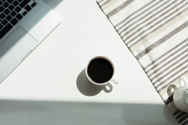 desk with laptop cand cup of coffee 