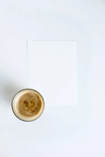 Cup of coffee on white paper — Stock Photo, Image