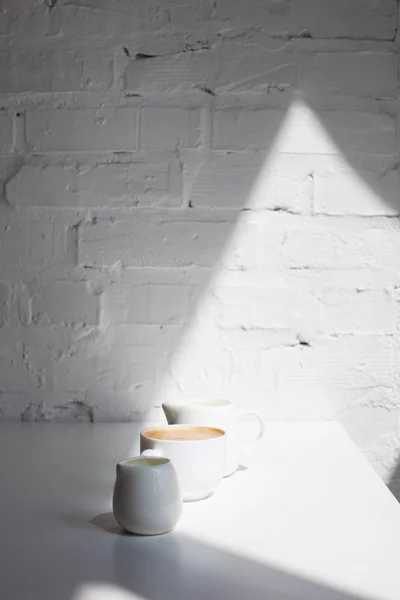 Чашка кави та молочних баночок — стокове фото