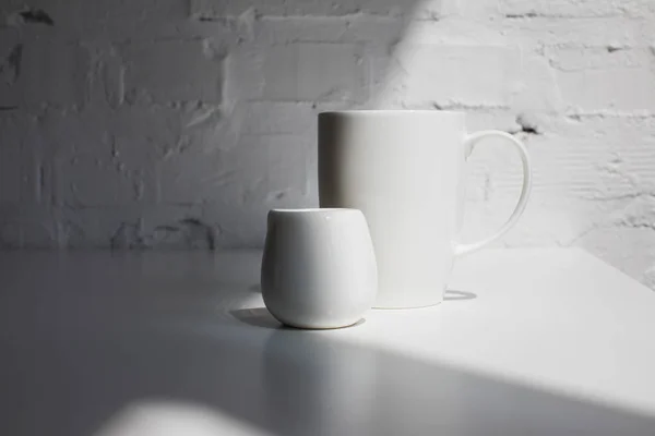 Cup of coffee and milk jar — Stock Photo, Image