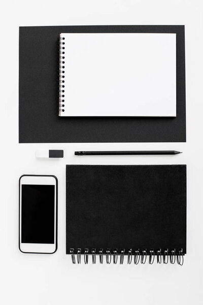 smartphone, notepads and office supplies