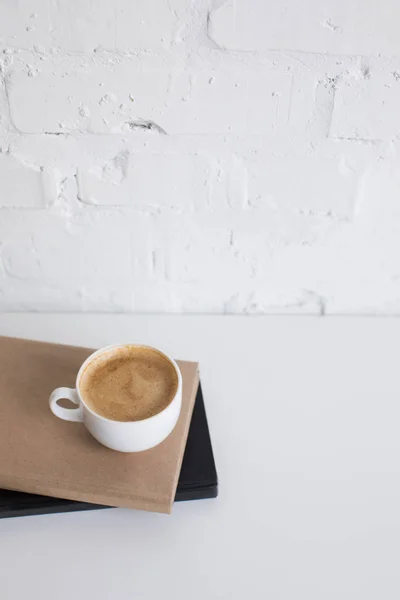 Cup of coffee on books — Stock Photo, Image