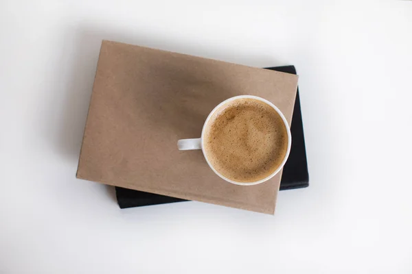 Cup of coffee on books — Stock Photo, Image