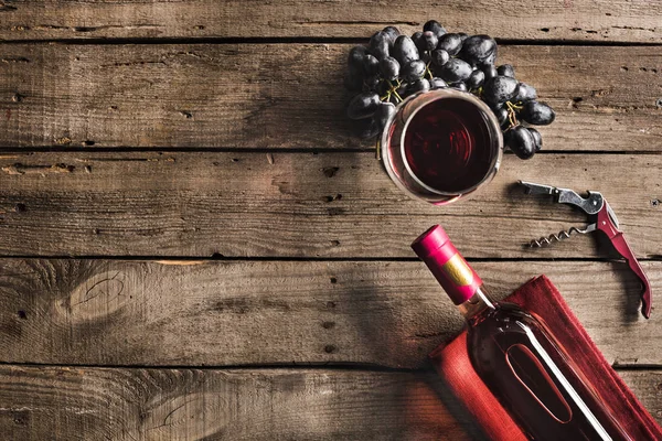 bottle of wine, wineglass and grapes