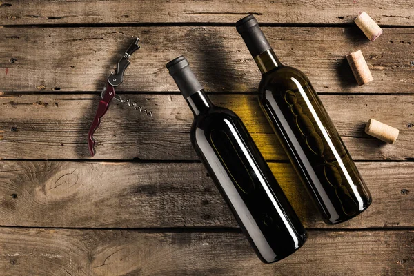 Bottle of red wine and corkscrew — Stock Photo, Image