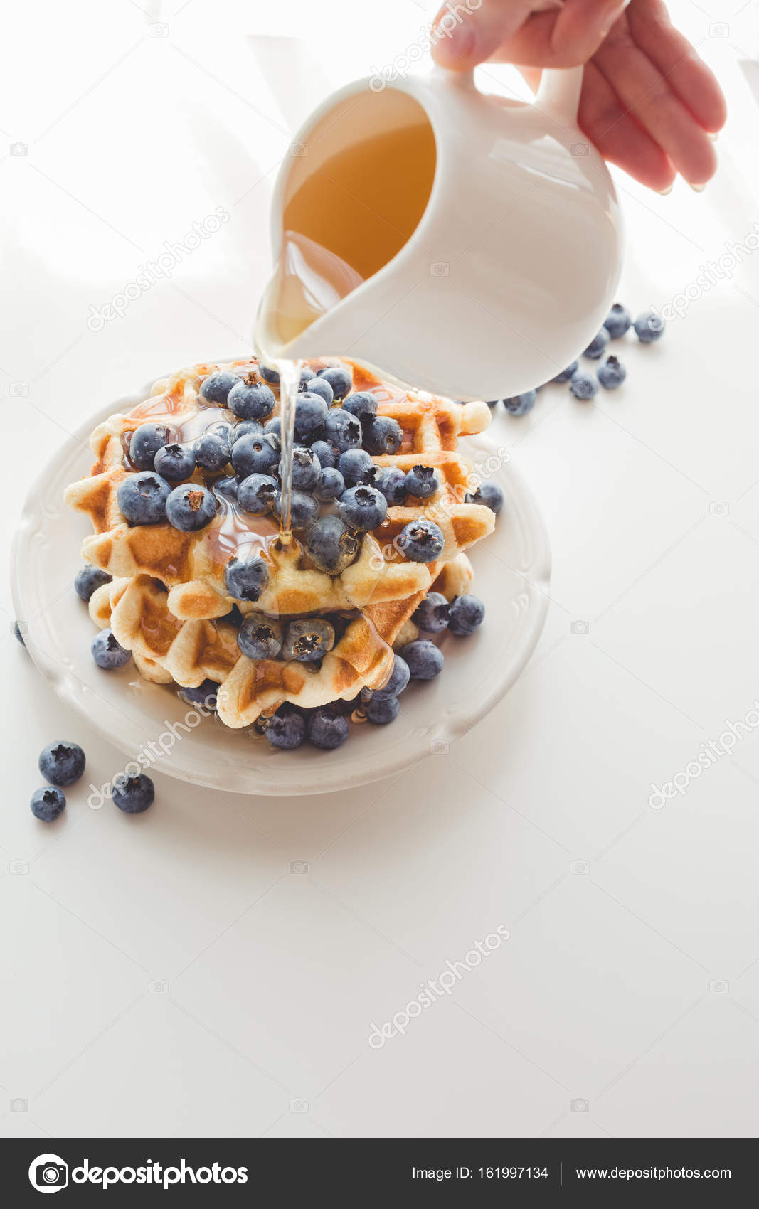 Woman pouring syrup on tasty waffles — Stock Photo © AntonMatyukha