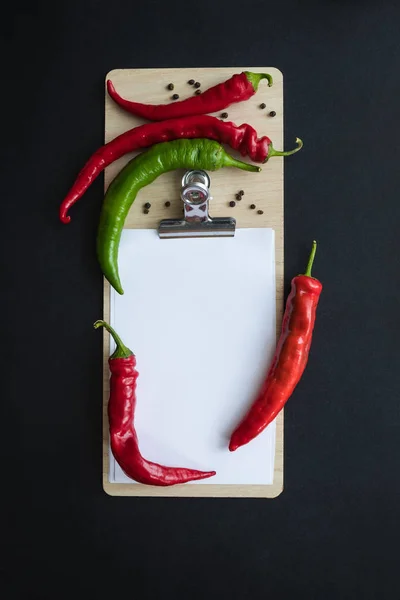 Peppers and blank paper sheet — Stock Photo, Image