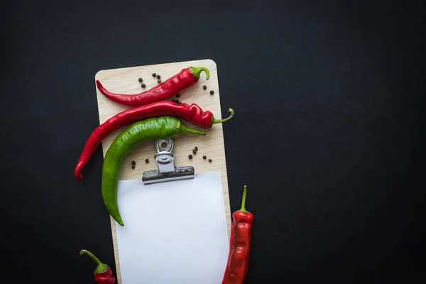 Peppers and blank paper sheet — Stock Photo, Image