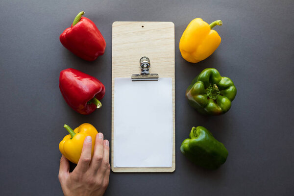 vegetables with blank paper and cutting board