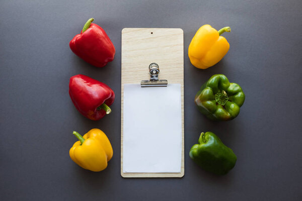 vegetables with blank paper and cutting board