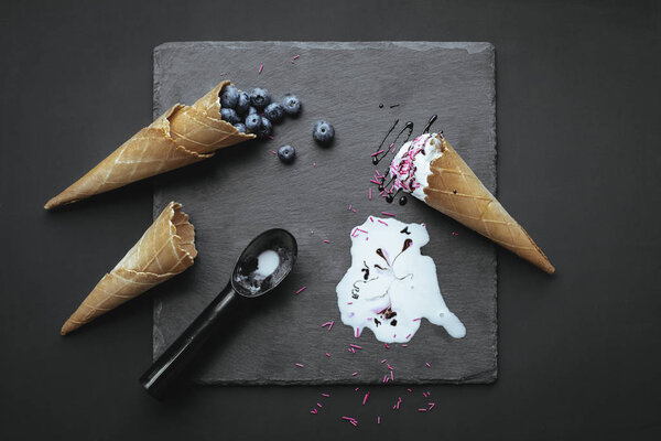 ice cream and blueberries in wafer cones