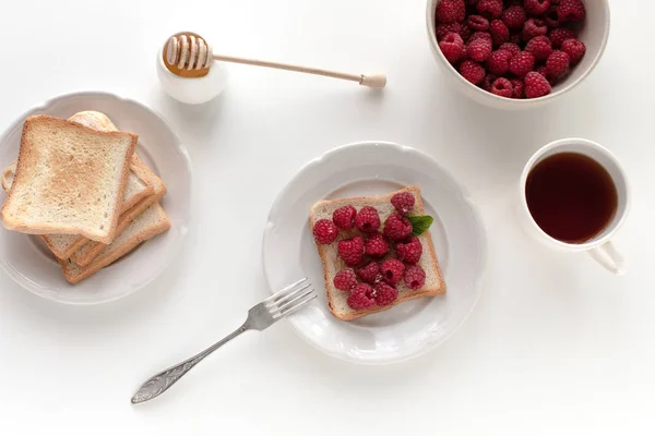 Toasts with raspberries for breakfast — Stock Photo, Image