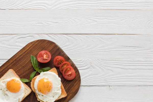 Fried eggs on toasts — Stock Photo, Image