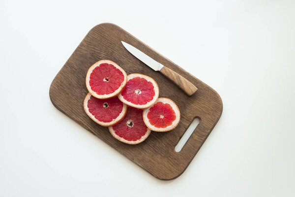 sliced grapefruit on cutting board