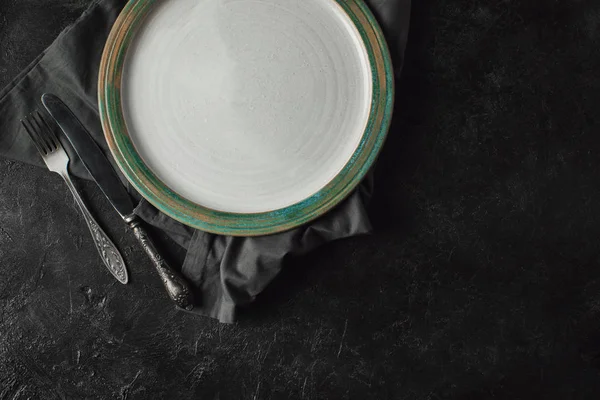 Silverware and plate on linen — Stock Photo, Image