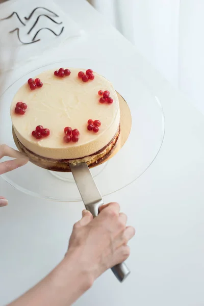 Nő szolgáló sajttorta bogyókkal — Stock Fotó