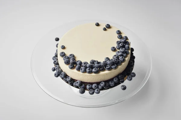 Cheesecake with blueberries on glass stand — Stock Photo, Image