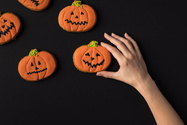 hand with halloween cookies