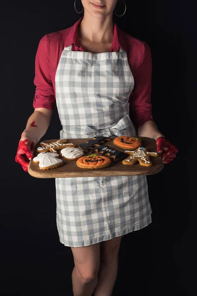 Girl holding tray with halloween cookies — Free Stock Photo