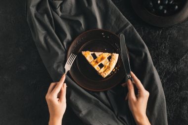 woman eating berry pie