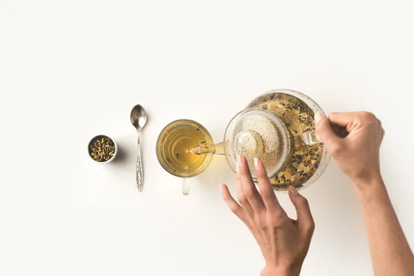 Person pouring herbal tea — Stock Photo, Image