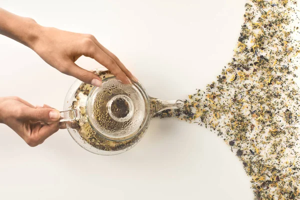 Person pouring herbal tea — Stock Photo, Image
