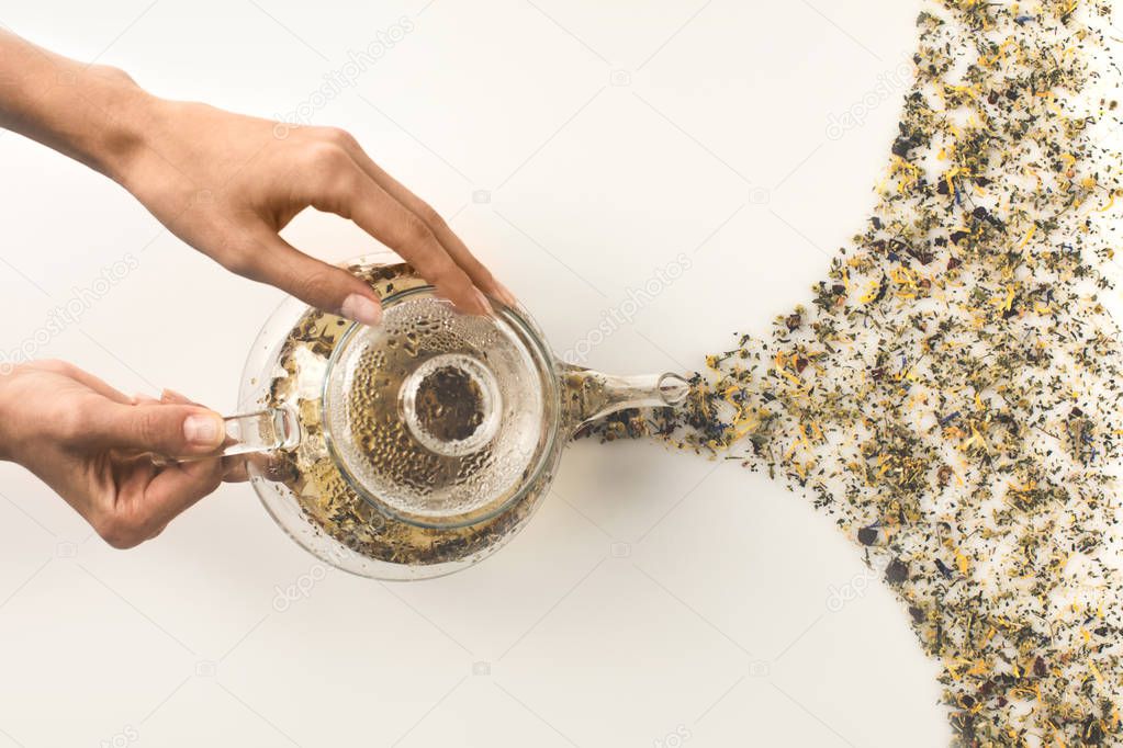 person pouring herbal tea