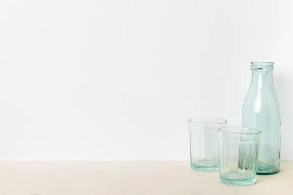 Empty glass bottle and glasses — Stock Photo, Image