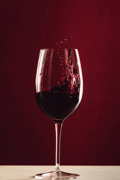 Splash of wine in wineglass — Stock Photo, Image