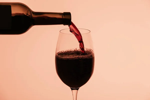 Red wine pouring from bottle — Stock Photo, Image