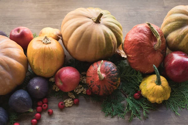 Pumpkins and fruits on table — Stock Photo, Image