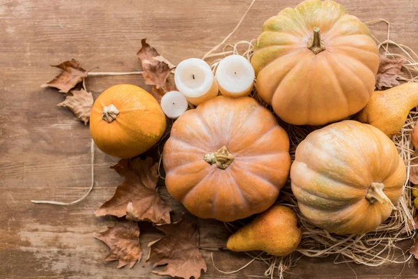 Pumpkins and candles on table — Stock Photo, Image