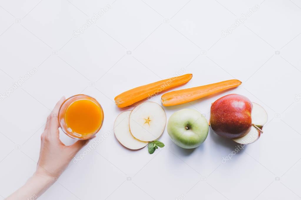 human hand and smoothie with ingredients