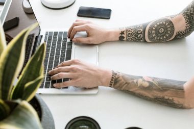 Dizüstü bilgisayarda yazan adam