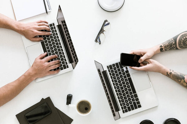 Two men working with laptops
