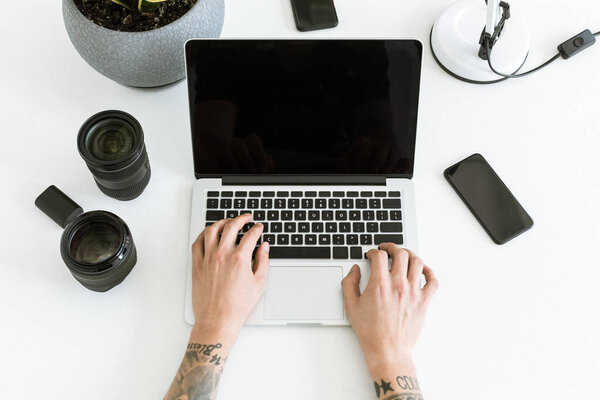 Male hands typing on laptop