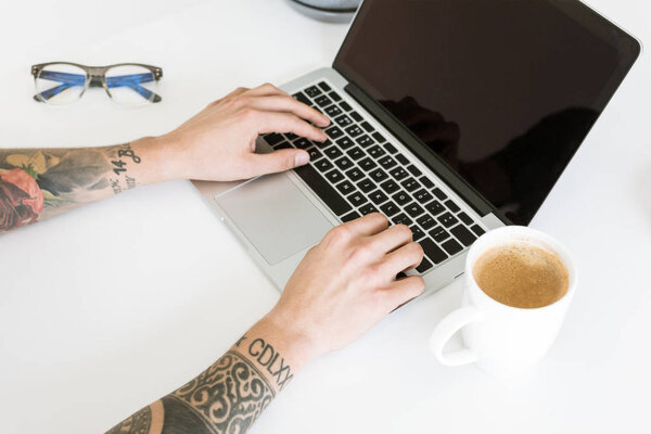 Male hands typing on laptop