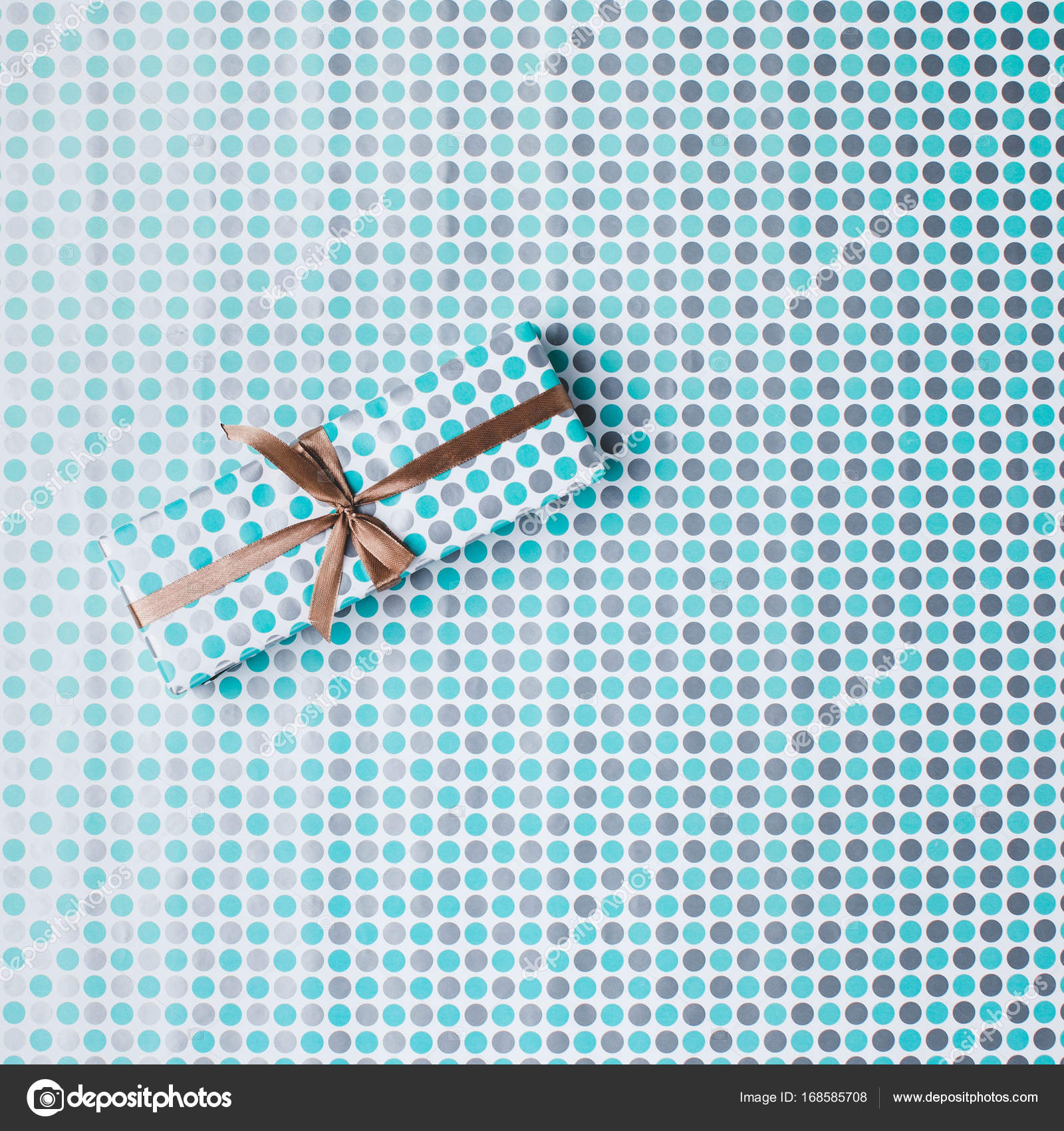 Christmas gift on wrapping paper — Stock Photo © AntonMatyukha 168585708