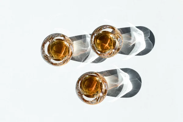 Whiskey in glasses with shadows — Stock Photo, Image