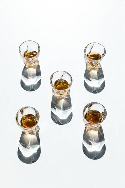 whiskey in glasses with shadows 