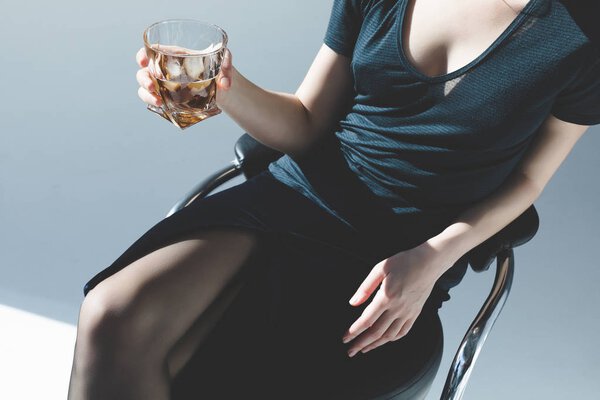 young woman drinking whiskey    
