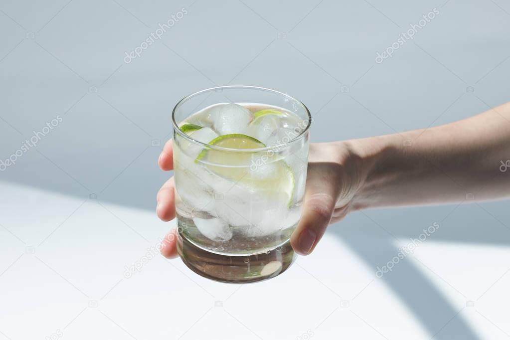 person holding glass with cocktail