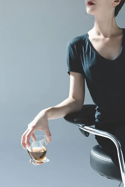 Woman holding glass with whiskey — Stock Photo, Image