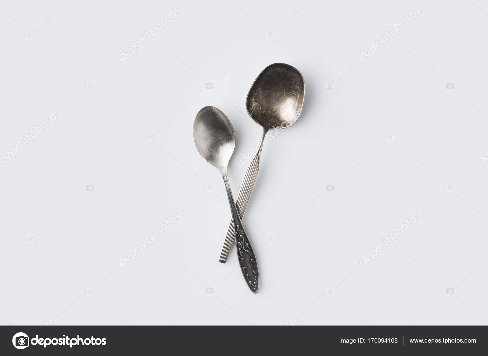 Crossed spoons on white table — Stock Photo © AntonMatyukha 170094108