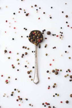 spoon with spilled peppercorns  clipart