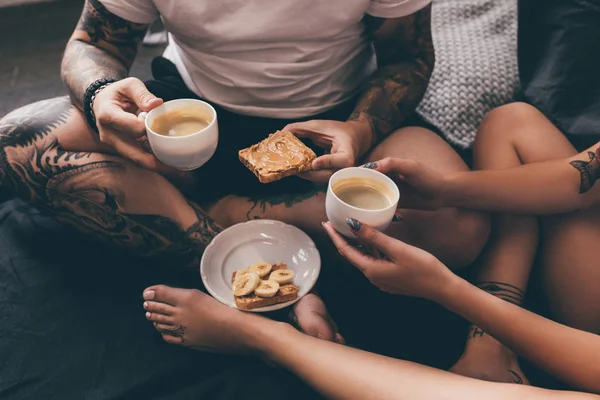 Couple with toasts and coffee in bed — Stock Photo, Image