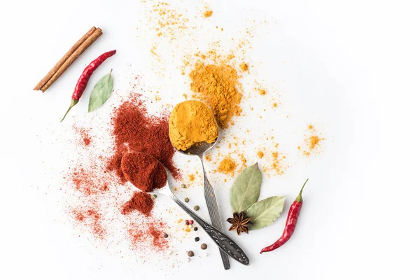 Spoons with paprika and curry — Stock Photo, Image