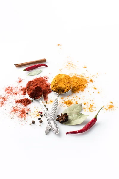 Spoons with paprika and curry — Stock Photo, Image