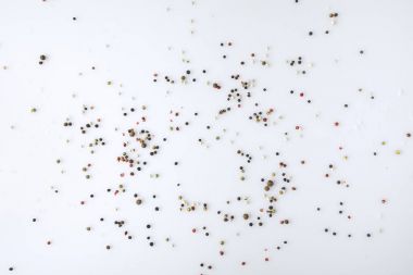 scattered pepper on white surface clipart
