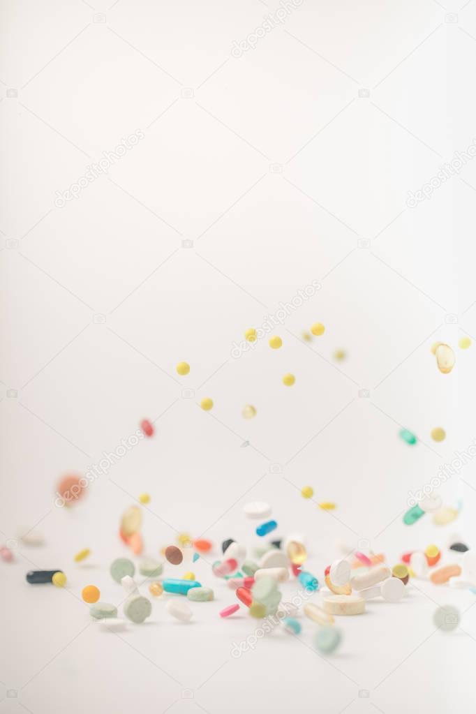 Colored pills spilling on surface